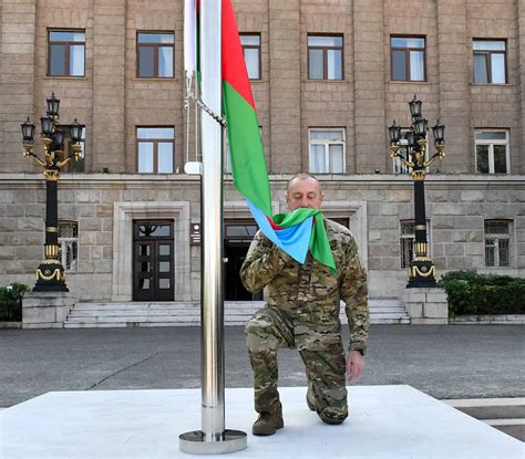 Azerbaijan’s president raises the nation’s flag in a former breakaway region’s capital